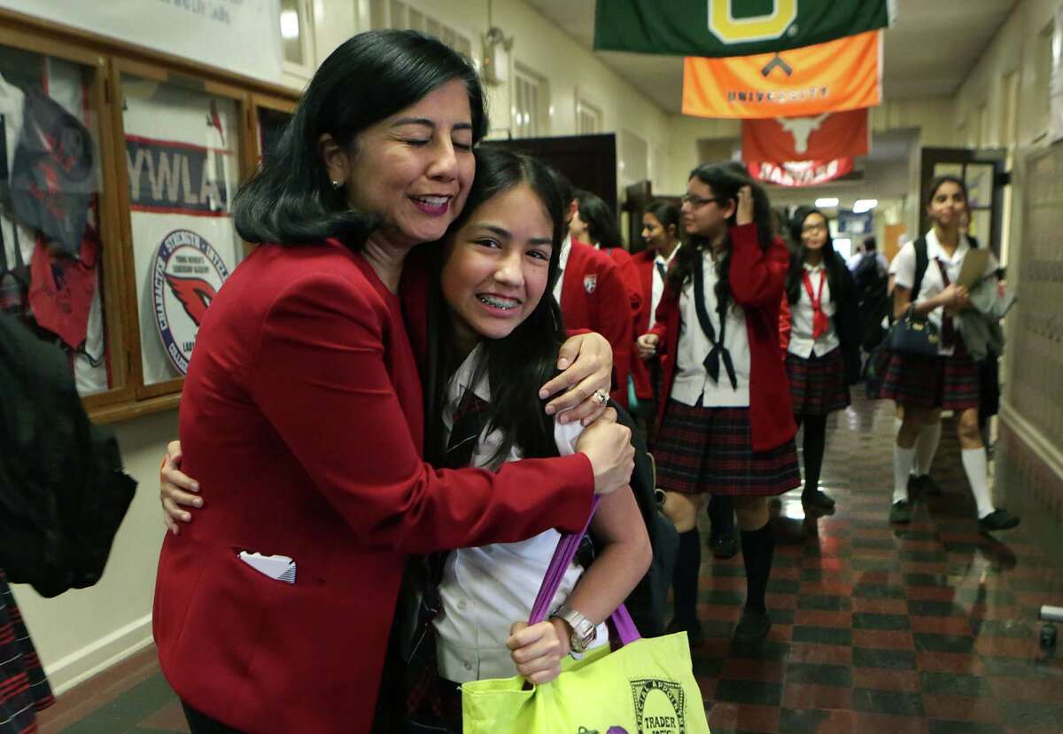 Delia McLerran, left, Principal at Young Women's Leadership Academy, is greeted by 8th grade student Lucia Conchas, after being named a finalist for the 2016 HEB Excellence in Education Awards as she is greeted by Betty Burks, left, a member of the school's advisory committee, on Monday, March 7, 2016.