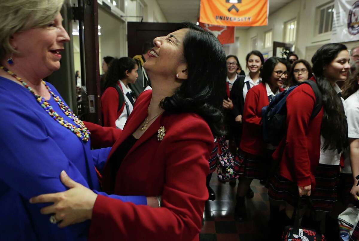 Delia McLerran, center, Principal at Young Women's Leadership Academy, reacts to being named a finalist for the 2016 HEB Excellence in Education Awards as she is greeted by Betty Burks, left, a member of the school's advisory committee, on Monday, March 7, 2016.