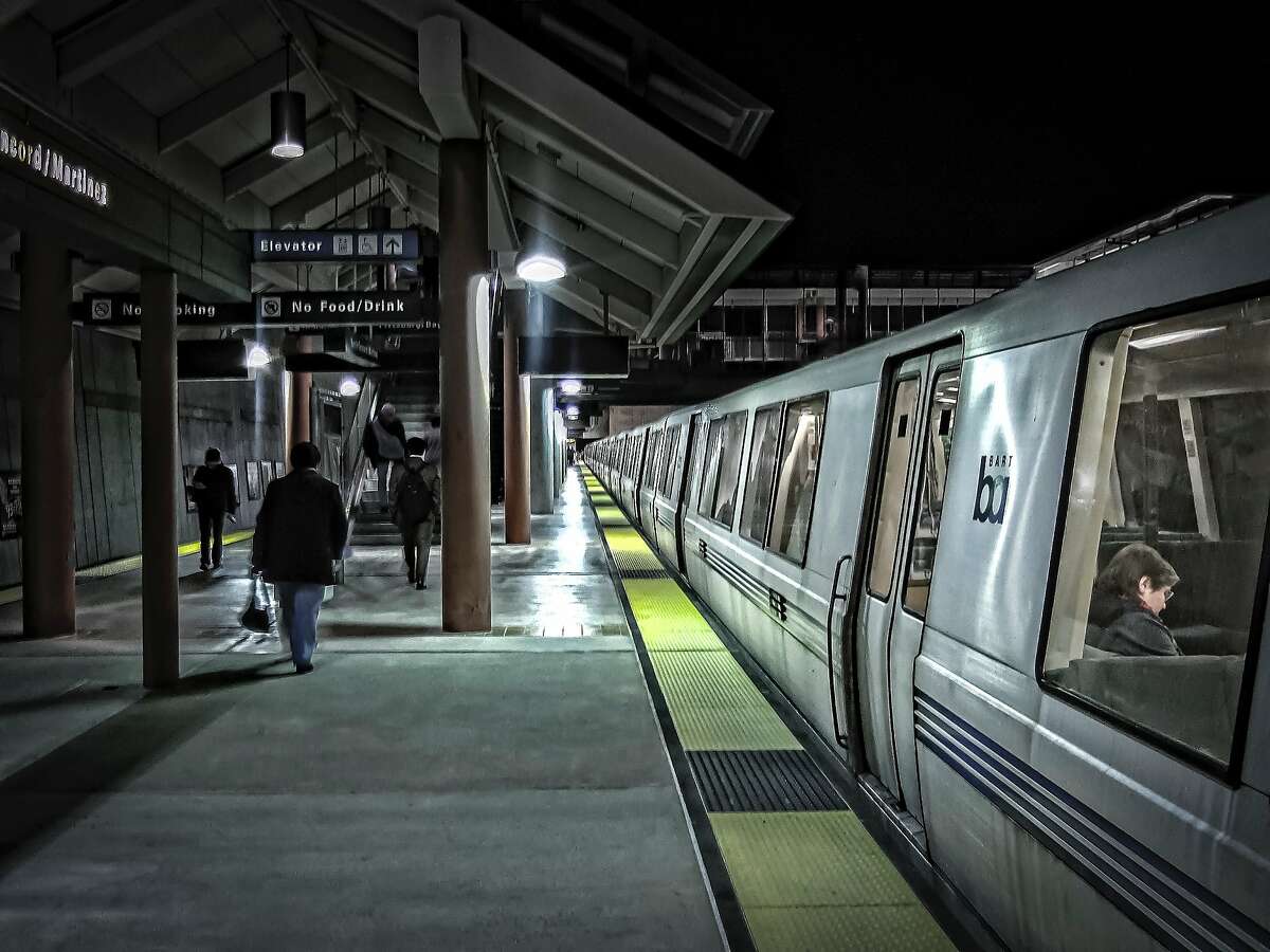 Commuters and train riders at the Concord/Martinez BART station at nighttime.