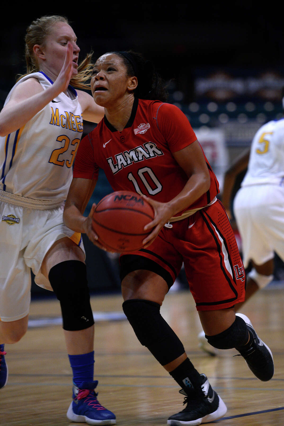 Lamar's Chastadie Barrs drives the lane against McNeese State's Amber Donnes during the second quarter in the Southland Conference tournament on Friday morning. The Cardinals lost 88-78, ending their season. Photo taken Friday 3/11/16 Ryan Pelham/The Enterprise