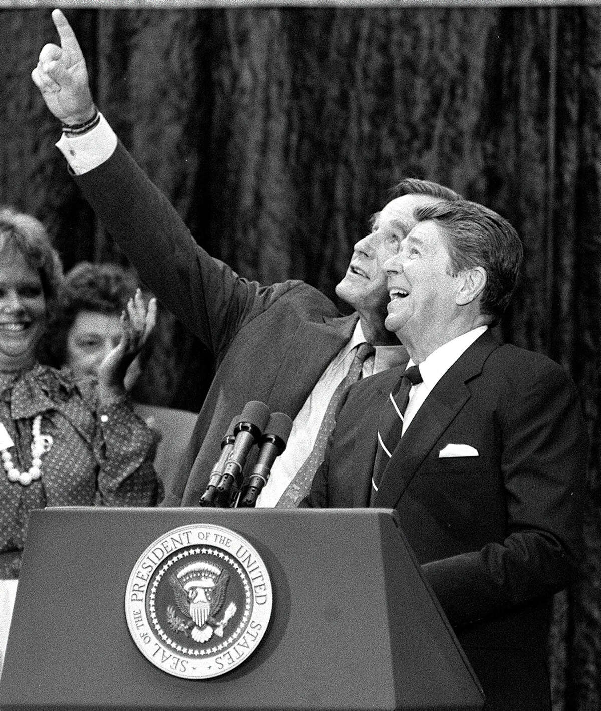 President Ronald Reagan and Vice President George H.W. Bush react to cheering suppporters and falling balloons at a rally at the Republican National Convention in Dallas, Texas, August 19, 1984.
