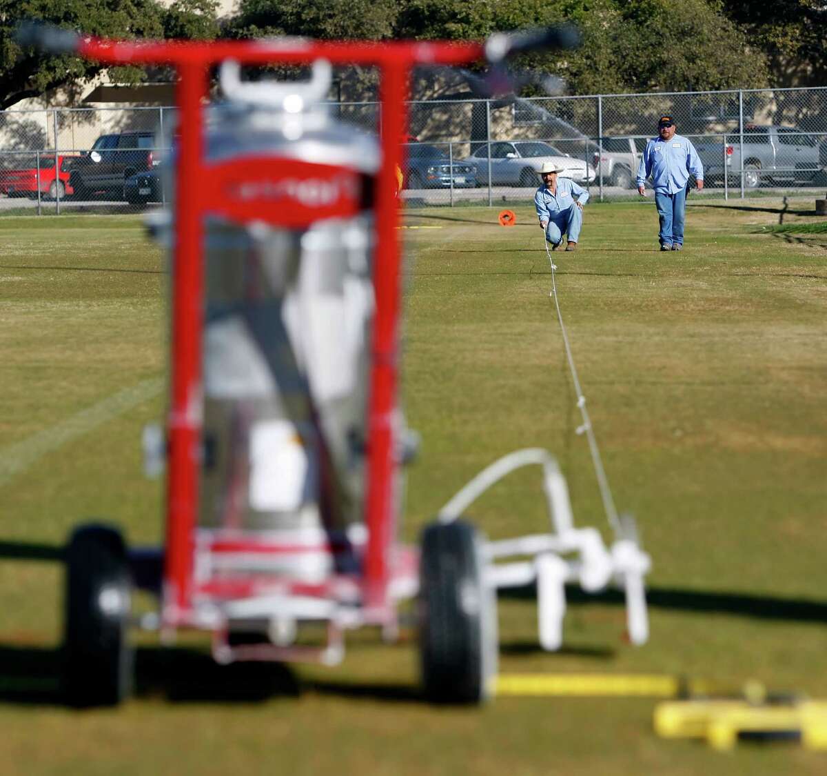 A San Antonio Independent School District employee prepares to stripe a field at the district’s sports complex. In the long run, a higher minimum wage would hurt district workers.