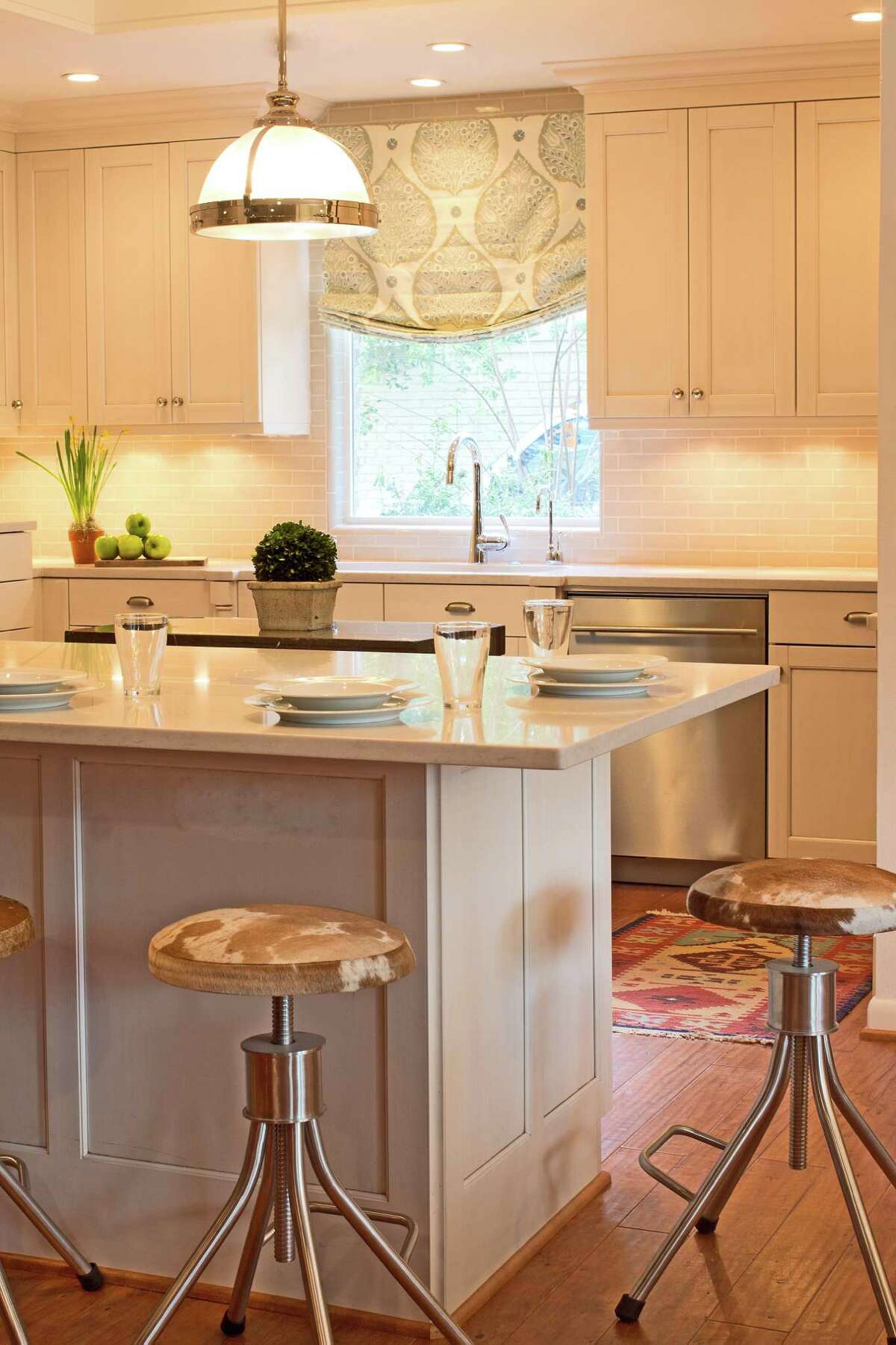 Silestone countertops and subway tile gave the Geisers' kitchen a bright, fresh look. The peninsula counter, which separates the kitchen from the family room, is now where they eat most of their casual meals.
