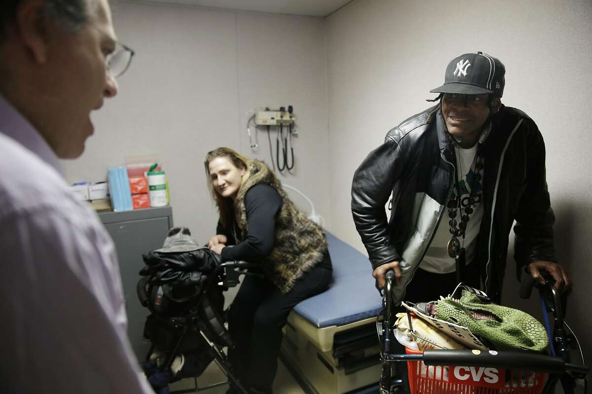 Dr. Barry Zevin (l to r), Homeless Outreach Team medical director, talks with Pier 80 shelter clients Melinda Welsh and Timothy Blevins at the Pier 80 medical clinic on Wednesday, March 9, 2016 in San Francisco, California.