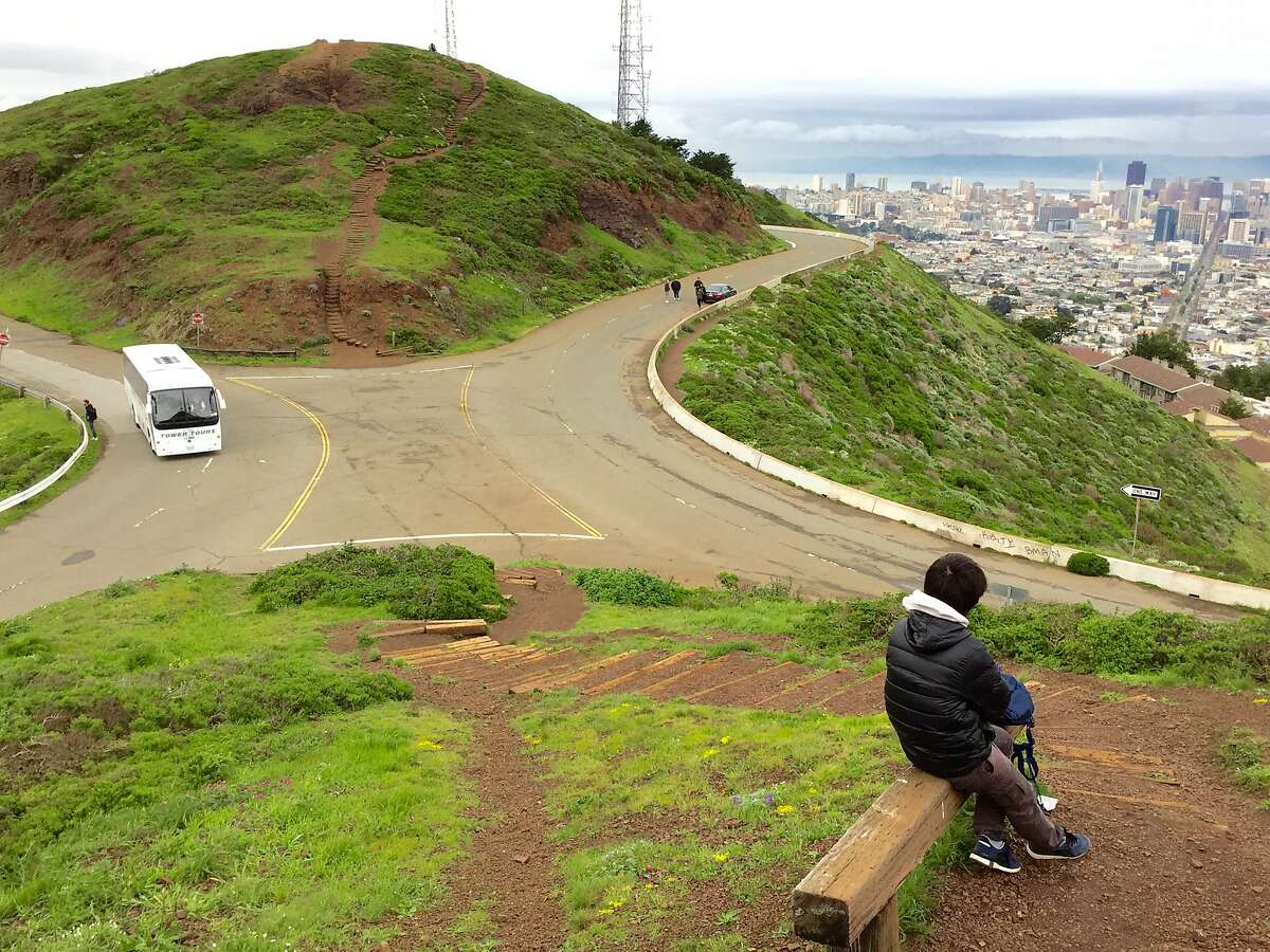 The east side of Twin Peaks Boulevard (to the right) would be closed to traffic as part of a pilot project by the city to improve hiking and pedestrian access to the scenic spot. Critics say it will make it more dangerous and harder to find parking.