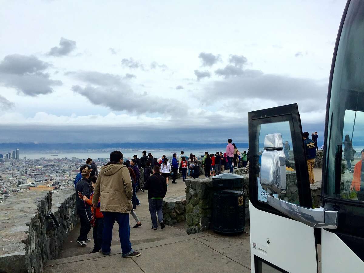 A bus load of foreign tourists enjoy the view from Christmas Tree Point on the southeast edge of Twin Peaks. Parking in the area could get more difficult� may get m