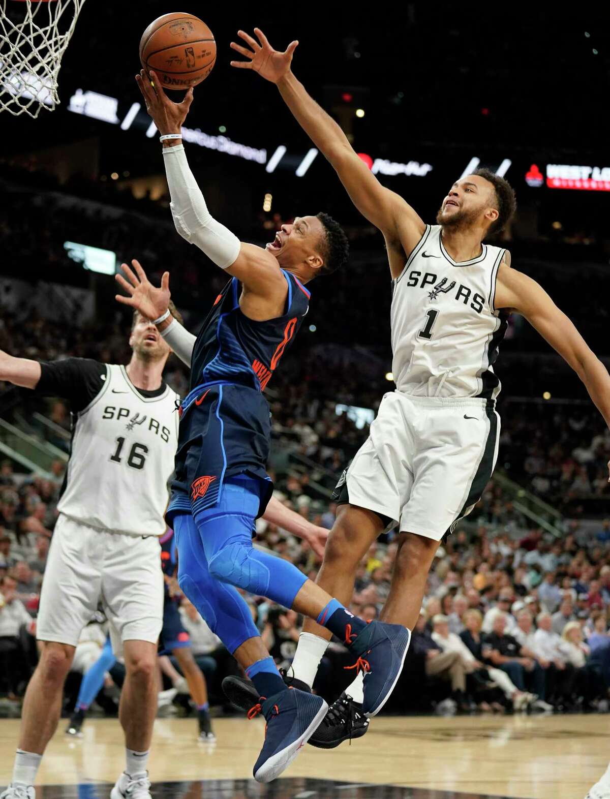 Oklahoma City Thunder's Russell Westbrook, center, shoots against San Antonio Spurs' Kyle Anderson (1) and Pau Gasol during the first half of an NBA basketball game Thursday, March 29, 2018, in San Antonio. (AP Photo/Darren Abate)