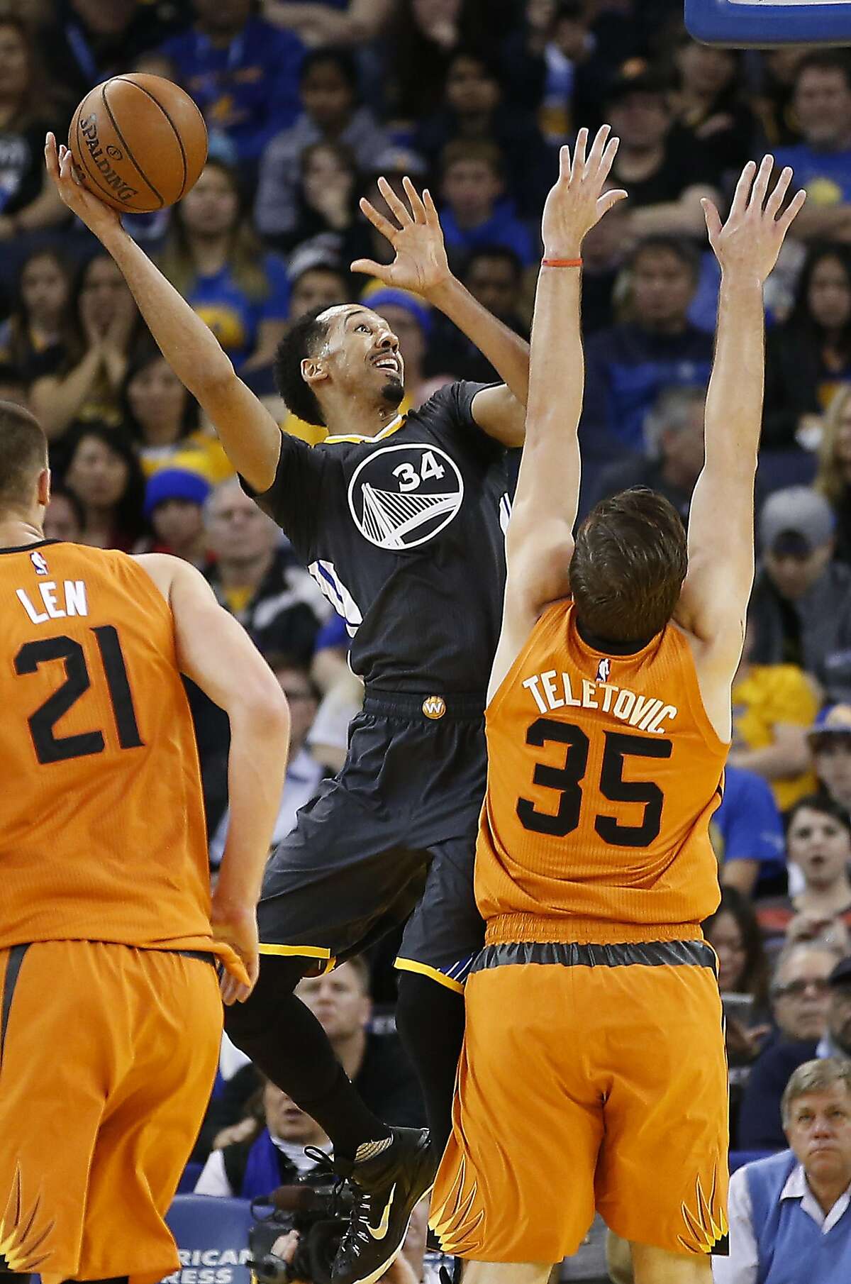 Golden State Warriors guard Shaun Livingston (34) takes a shot over Phoenix Suns forward Mirza Teletovic (35) during the first half NBA game at Oracle Arena in Oakland, Calif., on Saturday, March 12, 2016.