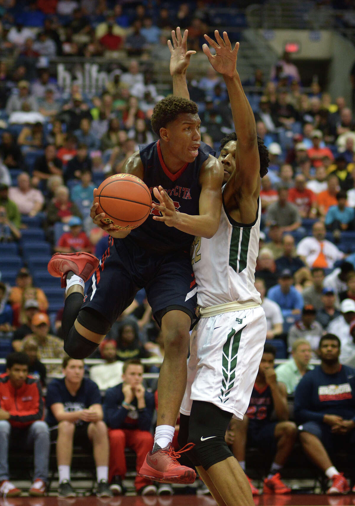 Atascocita junior forward Fabian White, left, battles for a shot against Desoto senior center Marques Bolden late in the 4th quarter of their Class 6A boys basketball state championship game at the Alamodome in San Antonio on Saturday, Mar. 12, 2016. (Photo by Jerry Baker/Freelance)