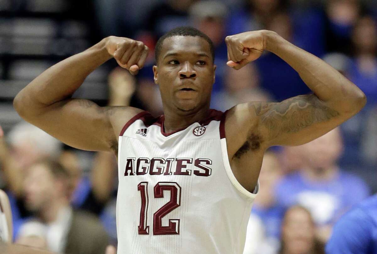 Texas A&M's Jalen Jones (12) celebrates after a basket against Kentucky during the first half of an NCAA college basketball game in the championship of the Southeastern Conference tournament in Nashville, Tenn., Sunday, March 13, 2016.