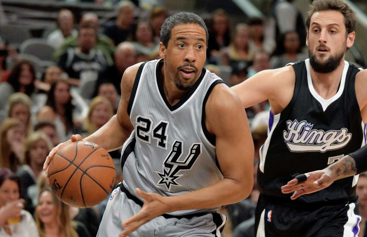 Spurs guard Andre Miller drives around Sacramento Kings forward Marco Belinelli during the second half on March 5, 2016, in San Antonio.