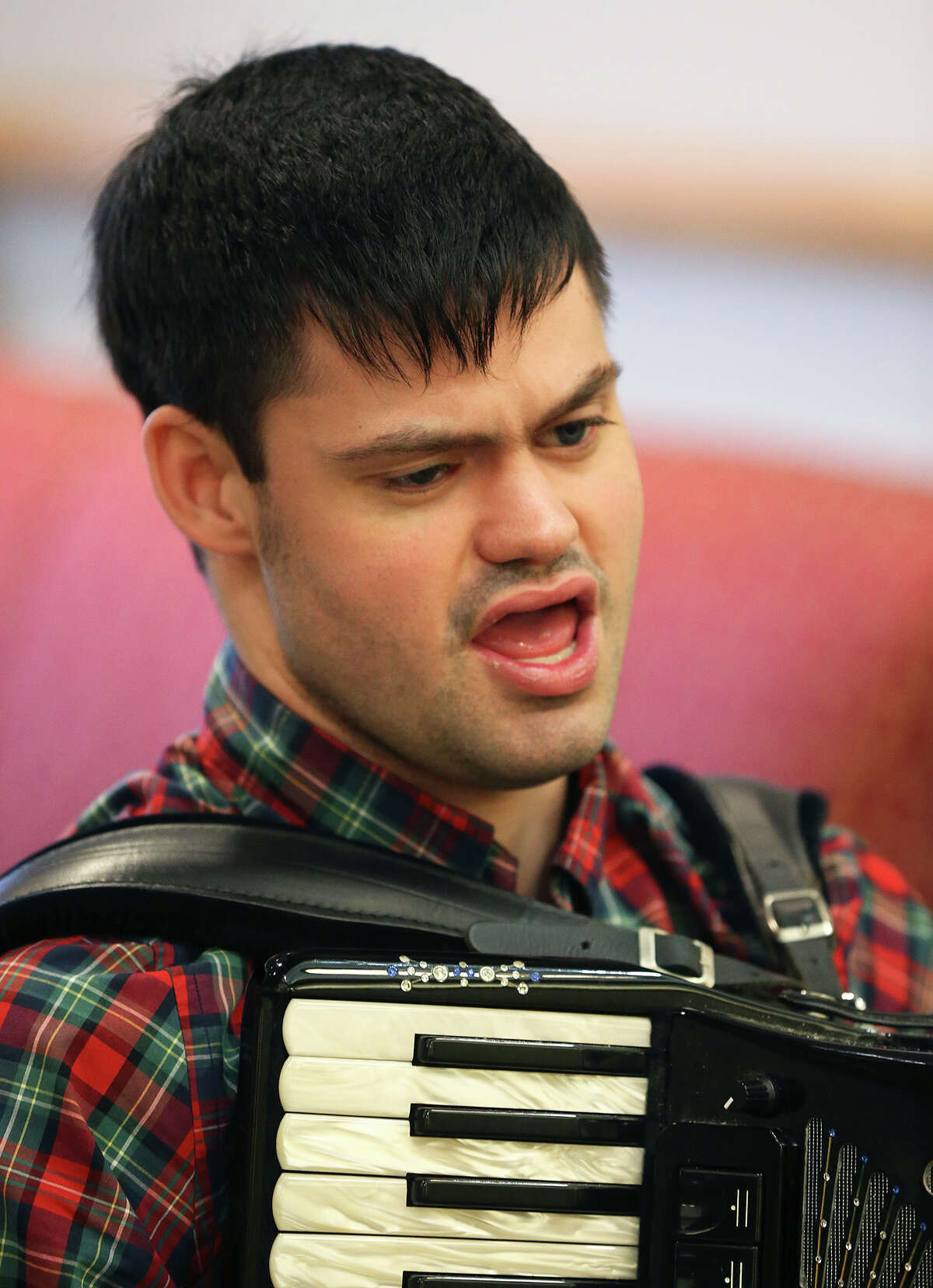 John McDonald, who has the developmental disorder Asperger's syndrome, which affects his ability to socialize and communicate effectively, performs a song on the accordion at the Kendall House Retirement Home in Boerne on Wednesday. McDonald is a good example of what autism experts advise all parents of autistic kids to do: Identify and cultivate their child’s special interests and talents as early as possible to improve the odds they’ll be able to make their own way in the world.