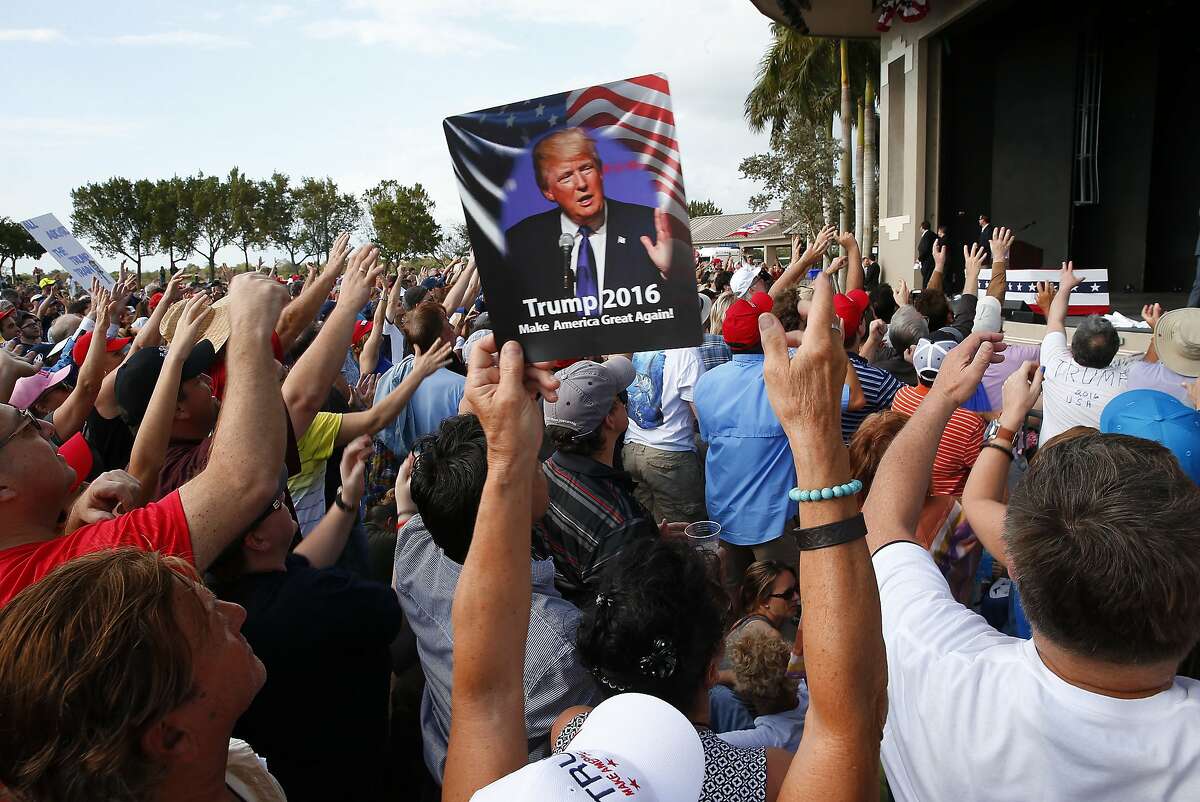 Audience members cheer at a Republican presidential candidate Donald Trump campaign rally in Boca Raton, Fla., Sunday, March 13, 2016. (AP Photo/Paul Sancya)