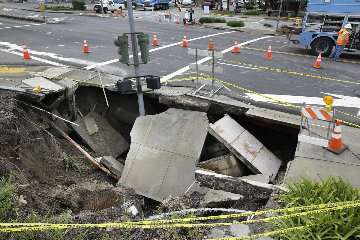 A sinkhole at the intersection of Rheem Boulevard and Center Street is seen on Monday, March 14, 2016 in Moraga, California.