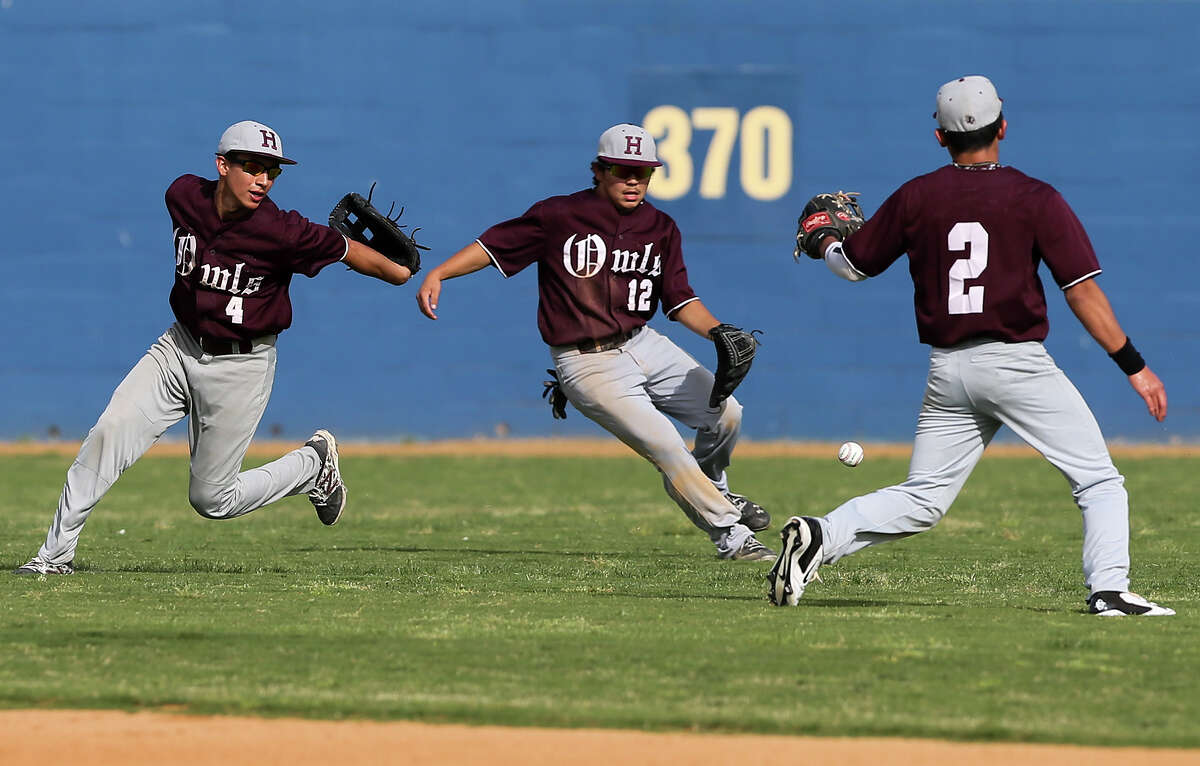 Highlands’ Josh Ortega (from left) Chris Ortiz and Bryan Aguilar converge on a ball hit to short center field during the fourth inning of their game with Edison at SAISD Field No. 1 on April 4, 2014.
