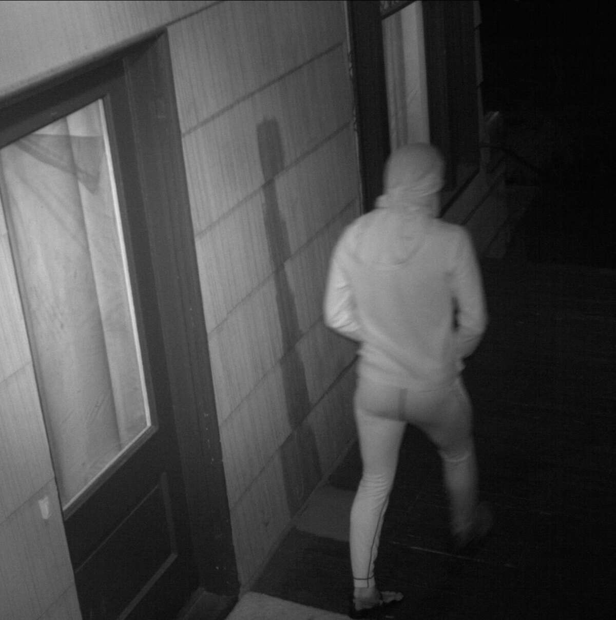 Seattle police seek this man, suspected of masturbating multiple times outside a University District home. He was caught on surveillance footage Feb. 7 wearing all black (which appears white in the image), including a wrap around his face and head and toe shoes.