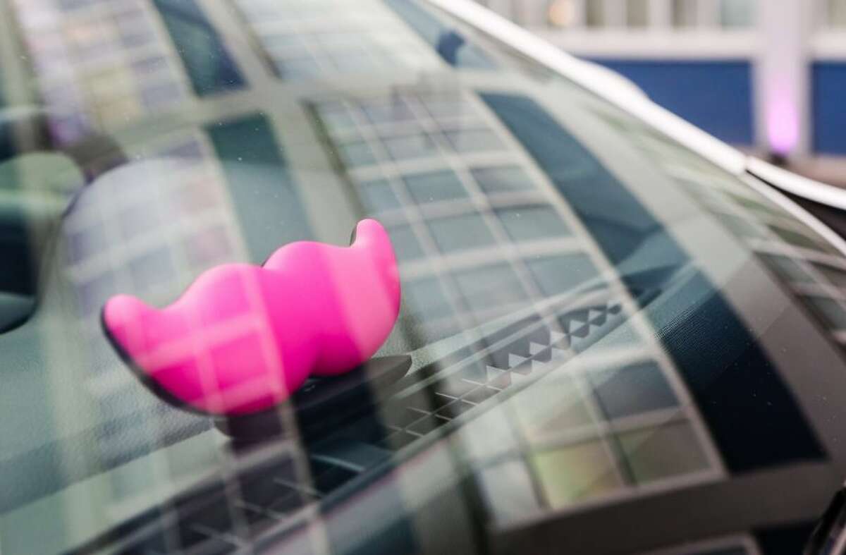 Lyft drivers cars are identified by the distinctive pink mustache.