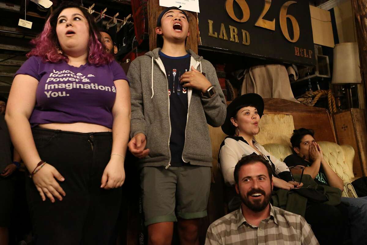 Youth Speaks members Rose Gelfand, 17, and Brandon Yip, 18, react to the announcement that there will be a tiebreaker at the Youth Speaks Teen Poetry Slam in San Francisco, Calif. on Friday, Feb. 27, 2016.