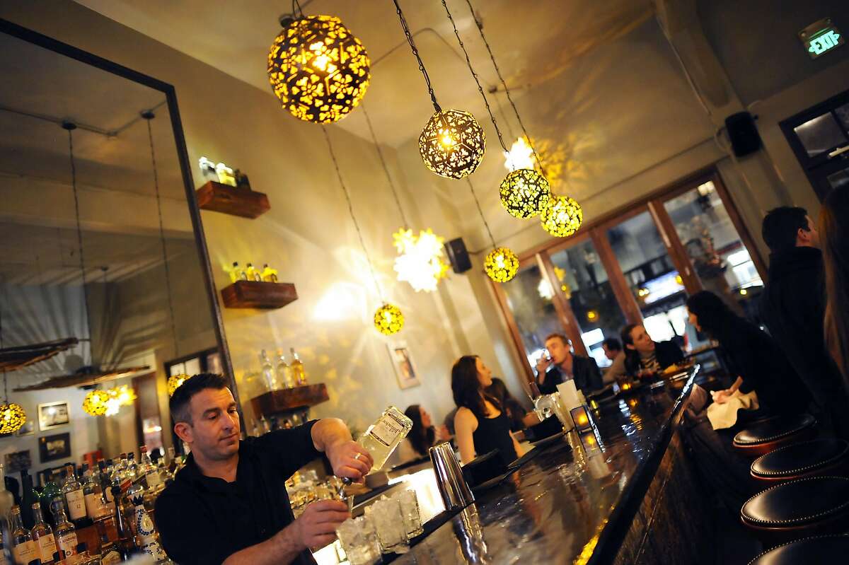 Bartender Brendan Card mixes a batch of fresh margaritas at the bar at Mamacita.