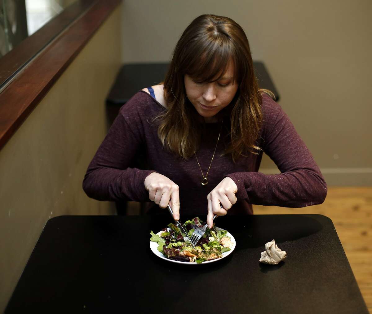 Ashley McCormack of Environmental Working Group eats a salad with salmon at a restaurant down the street from her office in Oakland, California, on Tuesday, March 15, 2016.
