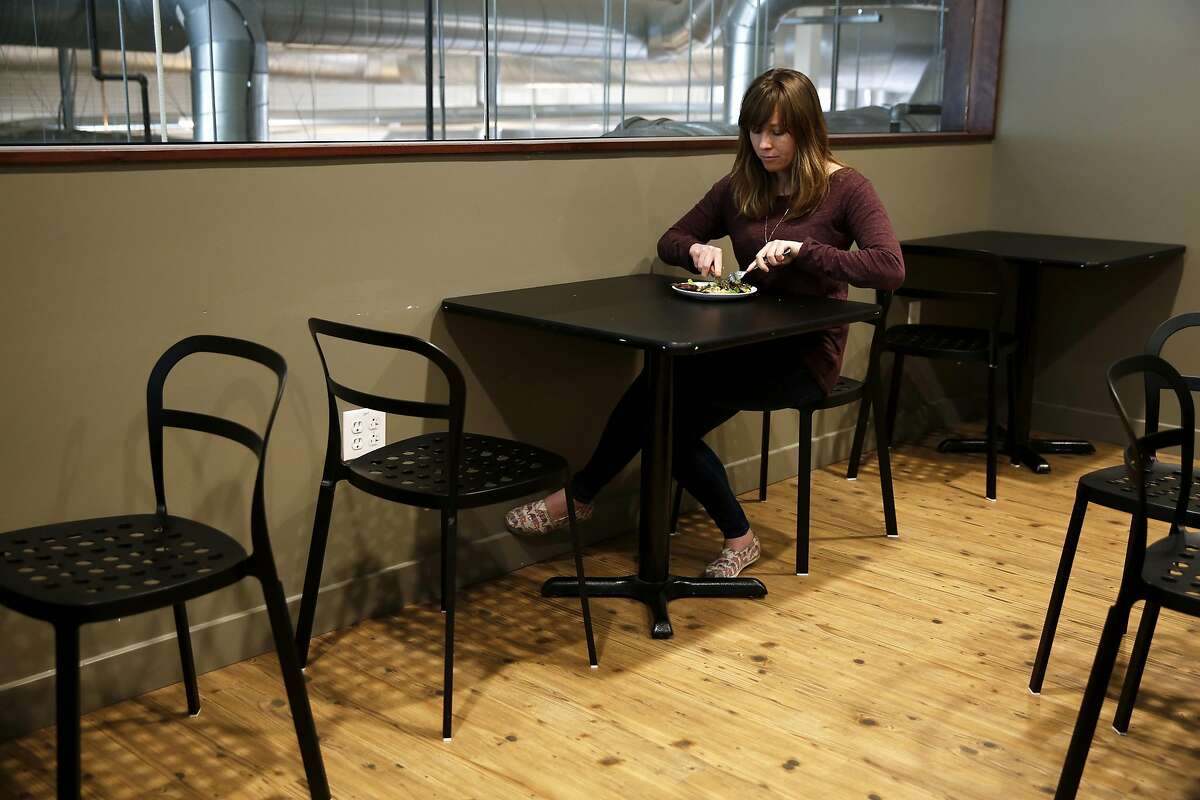 Ashley McCormack of Environmental Working Group eats a salad with salmon at a restaurant down the street from her office in Oakland, California, on Tuesday, March 15, 2016.