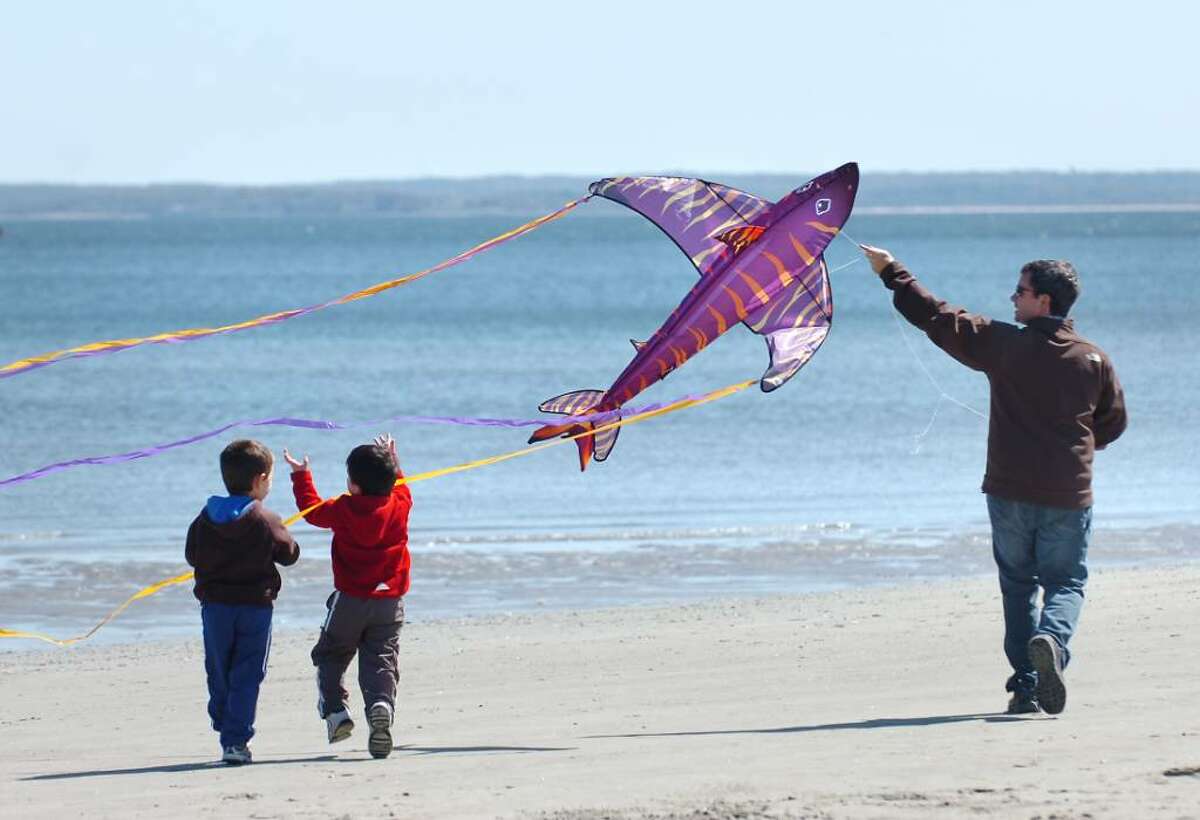 George D'Angelo, of Riverside, plays the Pied Piper with his fish kite as his two sons, Derek, 4, left, and Jake, 3, center, follow along during the annual Kite Flying Festival at Greenwich Point, Saturday afternoon, April 10, 2010.