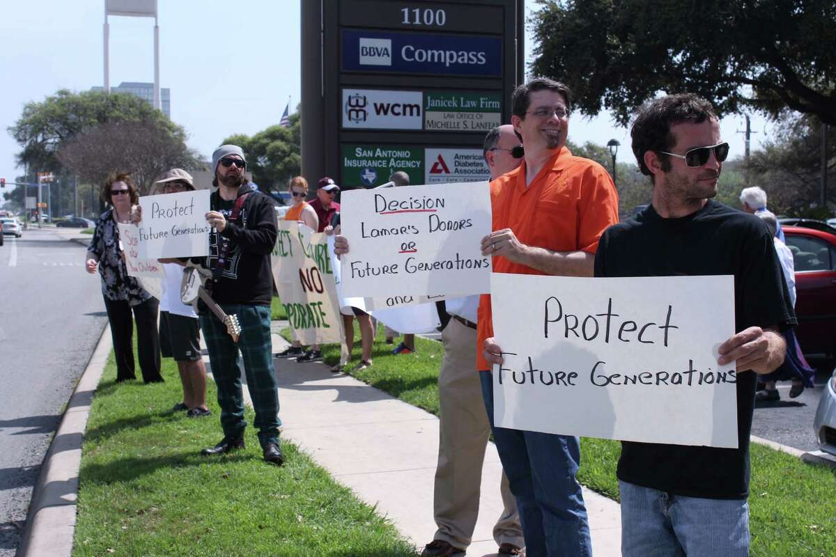 Protestors gather outside the San Antonio office of U.S. Rep. Lamar Smith last year to call attention to his efforts to discredit climate change science. One of our readers joins in the criticism.