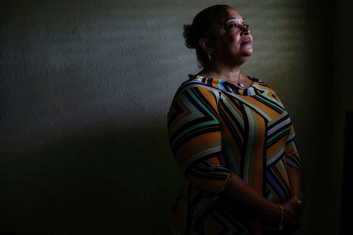 Precious Simon, ﻿former inmate at Harris County Jail, looks out the window of her new apartment in Houston on Tuesday﻿. The jail's diversion program, launched in 2013, is aimed at keeping people with mental illness out of jail and has helped Simon get her apartment, furniture, a job and clothes﻿. ﻿"I'm able to pay my bills again," she told the Chronicle with a smile.