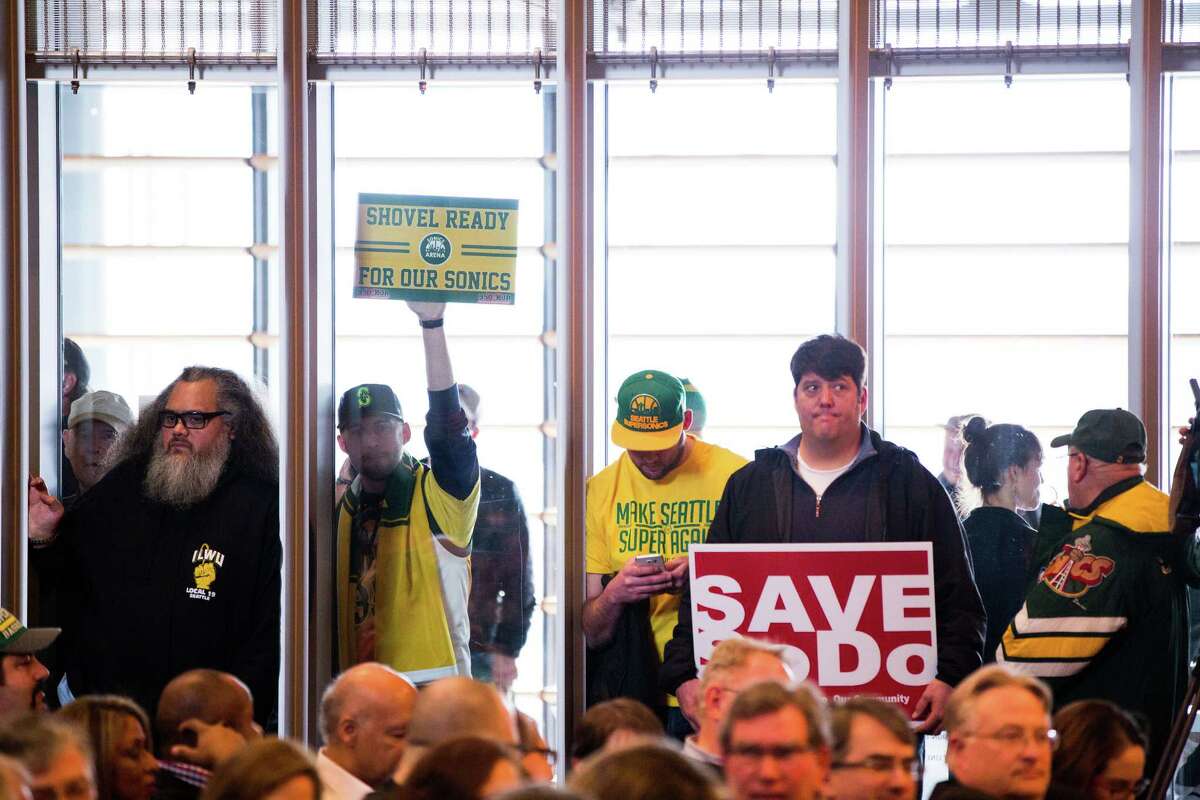 Supporters and opponents of the proposed Seattle SuperSonics SoDo arena show their allegiance during a hearing at Seattle City Hall on Tuesday, Mar. 15, 2016.