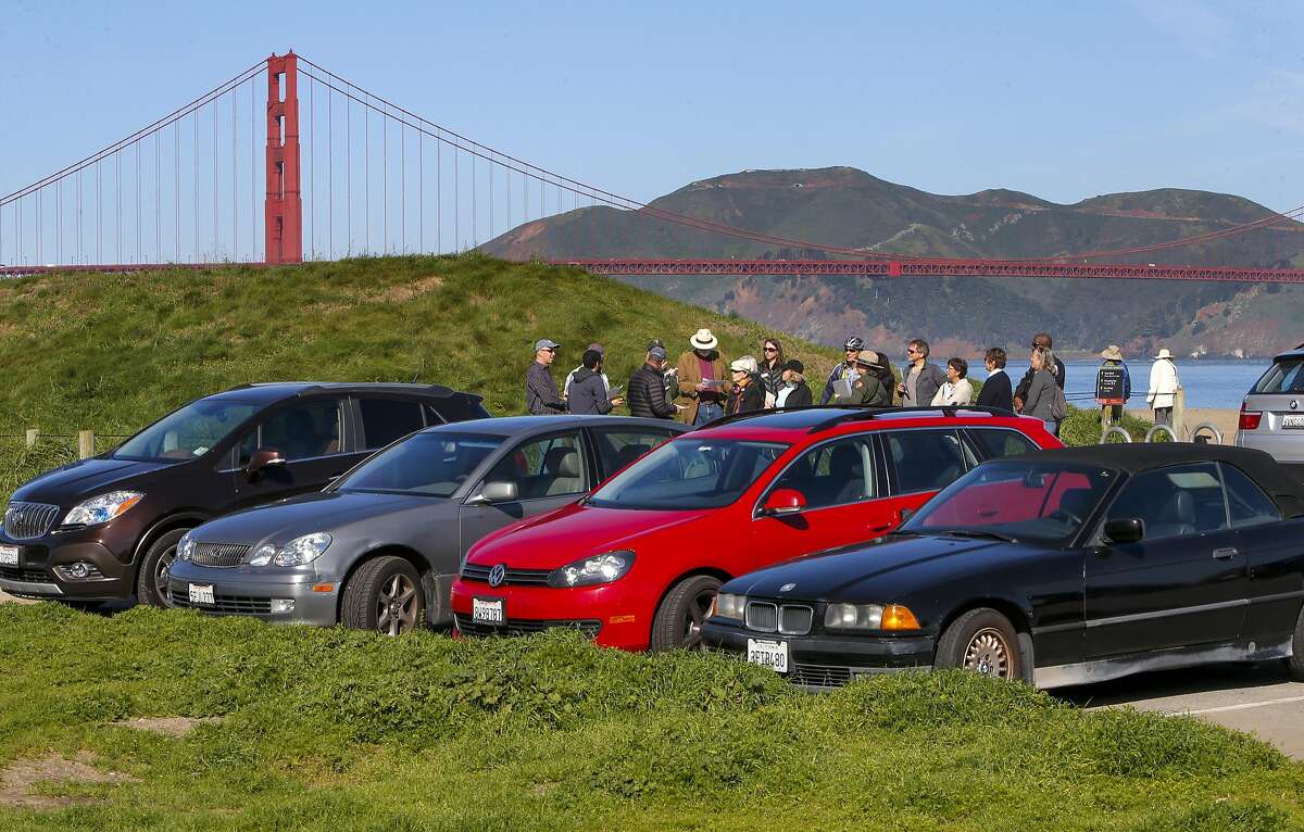 The west end of the parking lot will become a multi-purpose lawn area as community members pass by during a tour with the National Park Service on Wed. March 16, 2016, in San Francisco, California, to discuss the renovations plans of the East Beach parking area and promenade at Crissy Field taking place later this year.