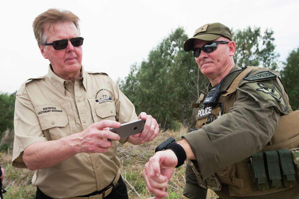 Lt. Gov. Dan Patrick, left, takes a photo of a wristband GPS that shows the location of Texas Ranger Major J.D. Robertson, right, and the location of the border surveillance cameras near him. Without real metrics, the state’s efforts have all the makings of boondoggle and heaping helpings from the public pork barrel for DPS.