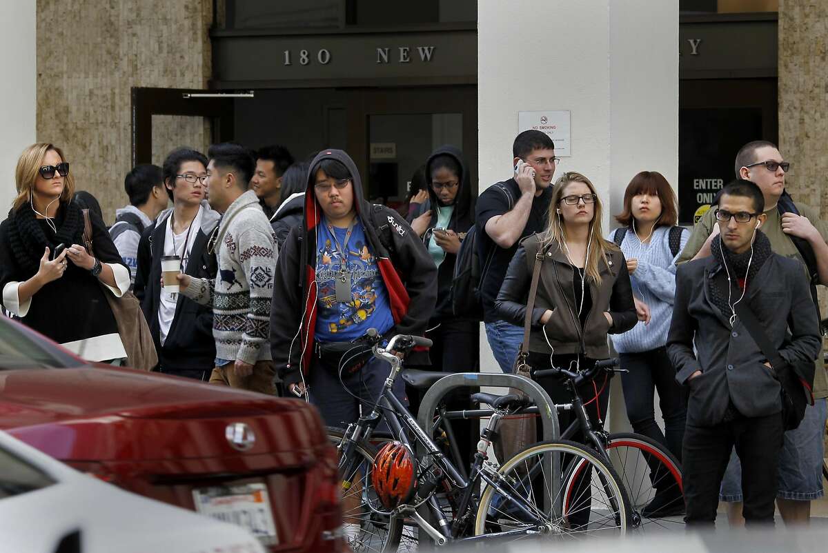 Art students file out of classes at the New Montgomery Street campus to wait for shuttles that crisscross the city. San Francisco City Attorney Dennis Herrera is questioning the possible improper conversion of buildings by the Academy of Art University into student housing and classrooms Tuesday November 13, 2012.