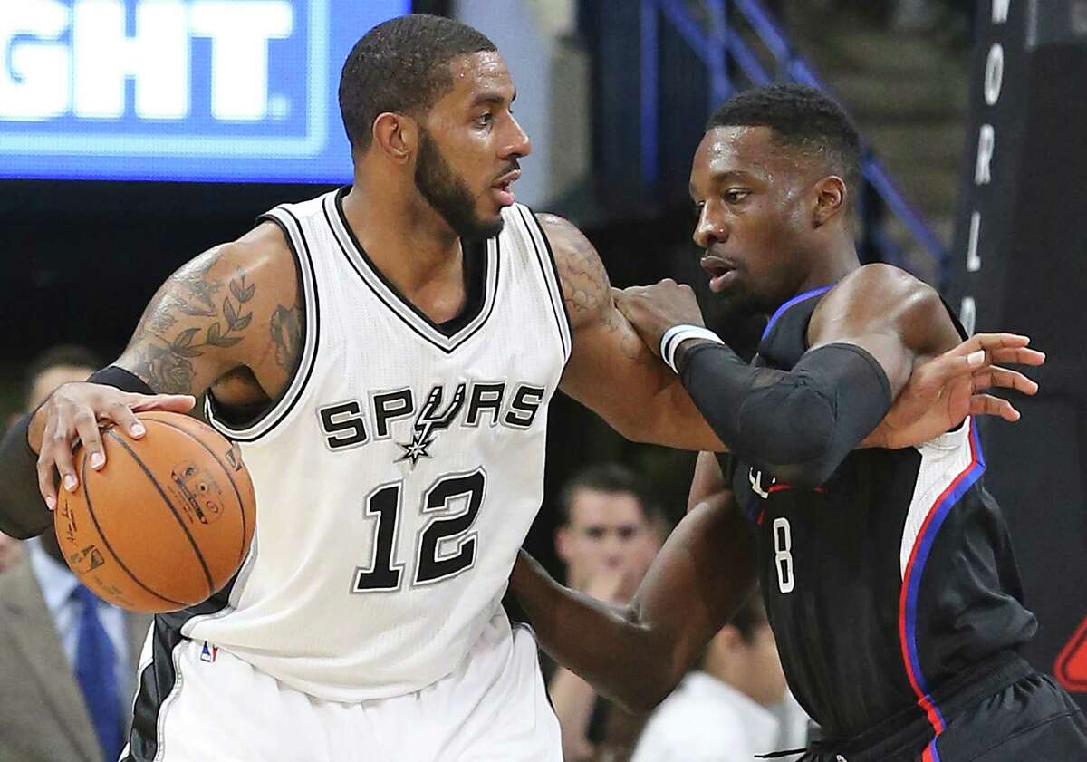 LaMarcus Aldridge posts up on Jeff Green as the Spurs host the Clippers at the AT&T Center on March 15, 2016.