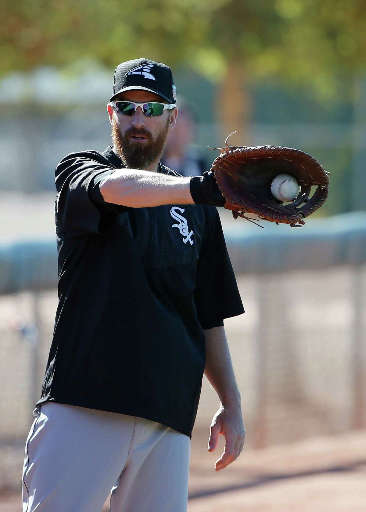 Chicago White Sox's Adam LaRoche catches the baseball as he warms up during a spring training baseball workout Wednesday, Feb. 24, 2016, in Glendale, Ariz. (AP Photo/Ross D. Franklin) ORG XMIT: AZRF117