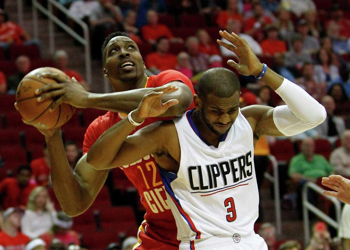 Rockets center Dwight Howard, left, tries to find some elbow room against Clippers guard Chris Paul during the first half of Wednesday night's game at Toyota Center. Howard didn't find much, scoring only six points.