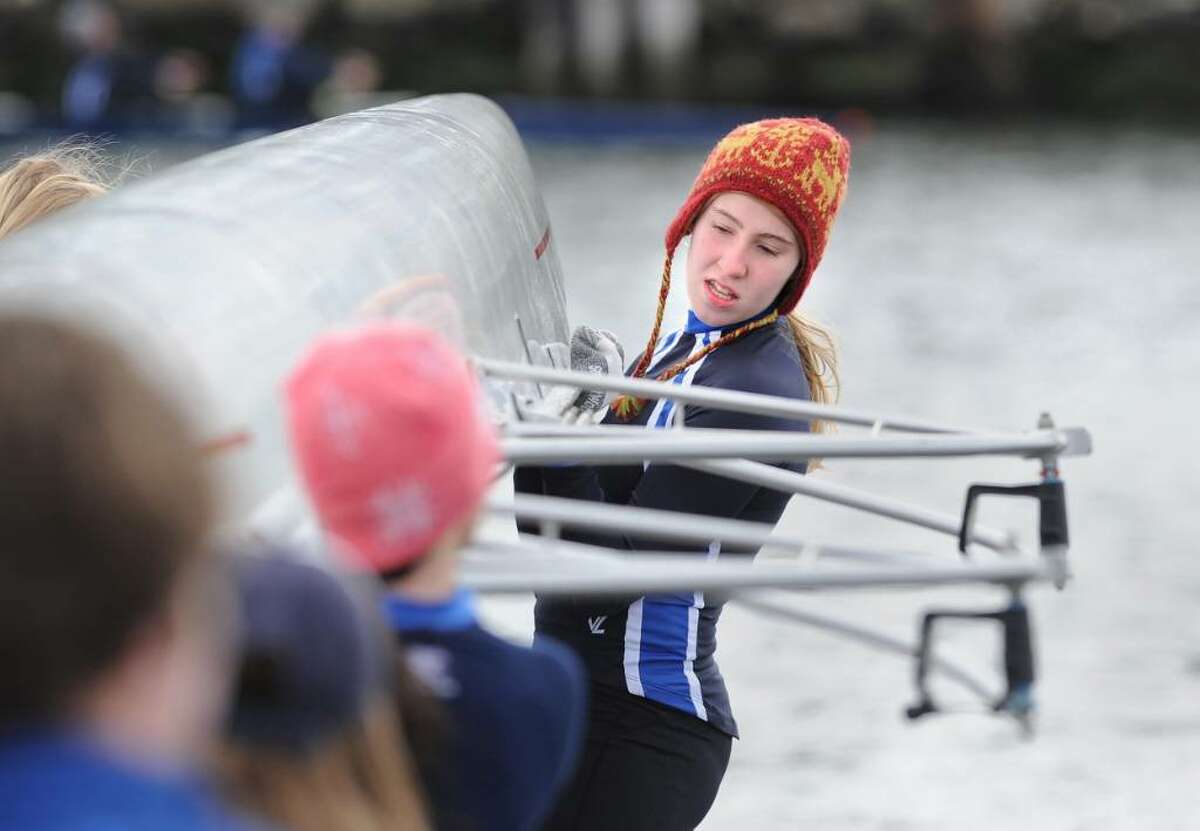 Grace Ingalls of the Greenwich Club crew team helps put her team's shell into Greenwich Harbor during the start of the NYPPEX Greenwich Invitational Sprints, April 10, 2010.