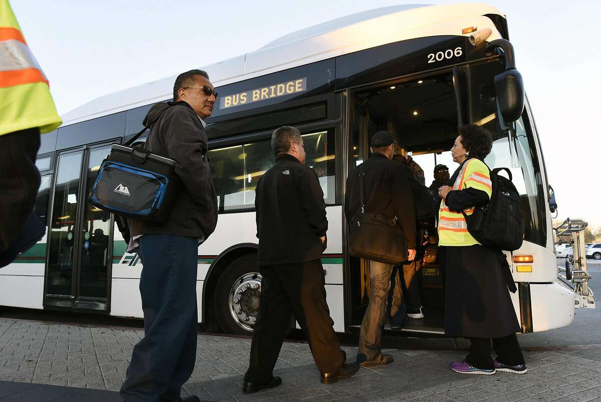 Customers line up to board free shuttle busses at the Pittsburg/Bay Point BART station in Pittsburg, CA Thursday, March 17, 2016. Free shuttle bus service was offered as BART service was out between the Pittsburg/Bay Point and Concord stations due to an electrical problem.