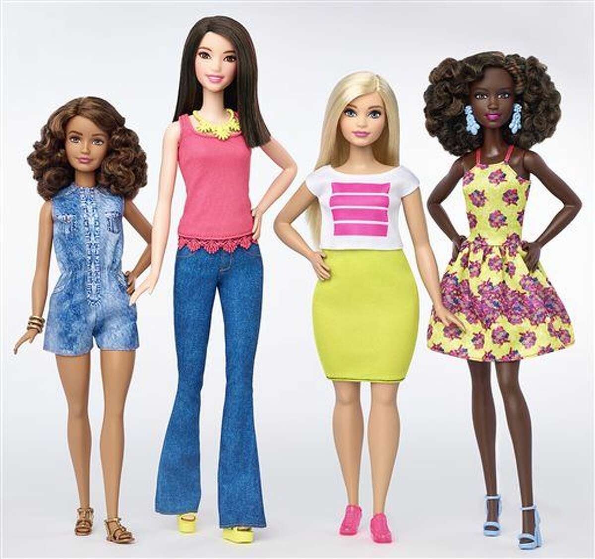 This photo provided by Mattel shows a group of new Barbie dolls introduced in January 2016. Mattel, the maker of the famous plastic doll, said it will start selling Barbie’s in three new body types: tall, curvy and petite. She’ll also come in seven skin tones, 22 eye colors and 24 hairstyles. (Mattel via AP)