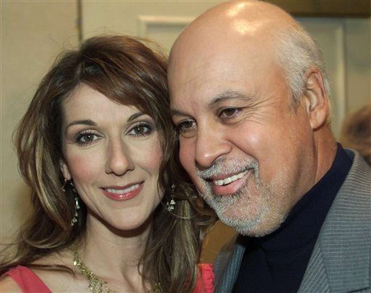 FILE - In this March 26, 2002 file photo, singer Celine Dion and her husband, Rene Angelil, arrive for press interviews to promote her new album "A New Day Has Come" in New York. Authorities say Angelil, the husband and manager of Dion, has died in Las Vegas. He was 73 and had battled throat cancer. Clark County Coroner John Fudenberg said his office was notified Thursday, Jan. 14, 2016, of Angelil’s death. (Ryan Remiorz, The Canadian Press via AP, File)