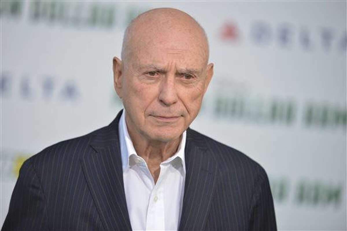 In this May 2014 file photo, Alan Arkin arrives at the world premiere of "Million Dollar Arm" in Los Angeles. A publicist says the 81-year-old Oscar-winning actor  was hospitalized after a minor stroke but was fine and back reading scripts on Friday.