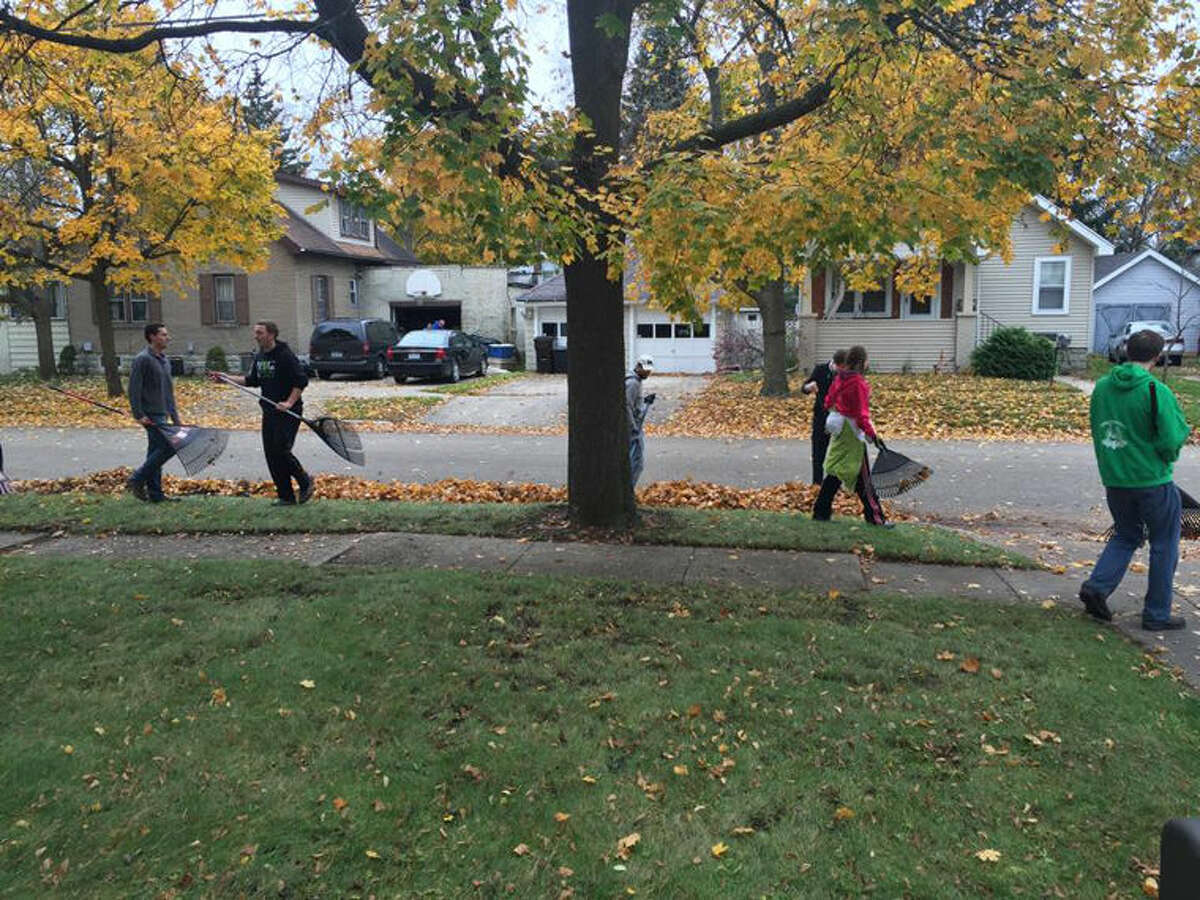 The youths are shown raking up a yard in a Midland neighborhood.