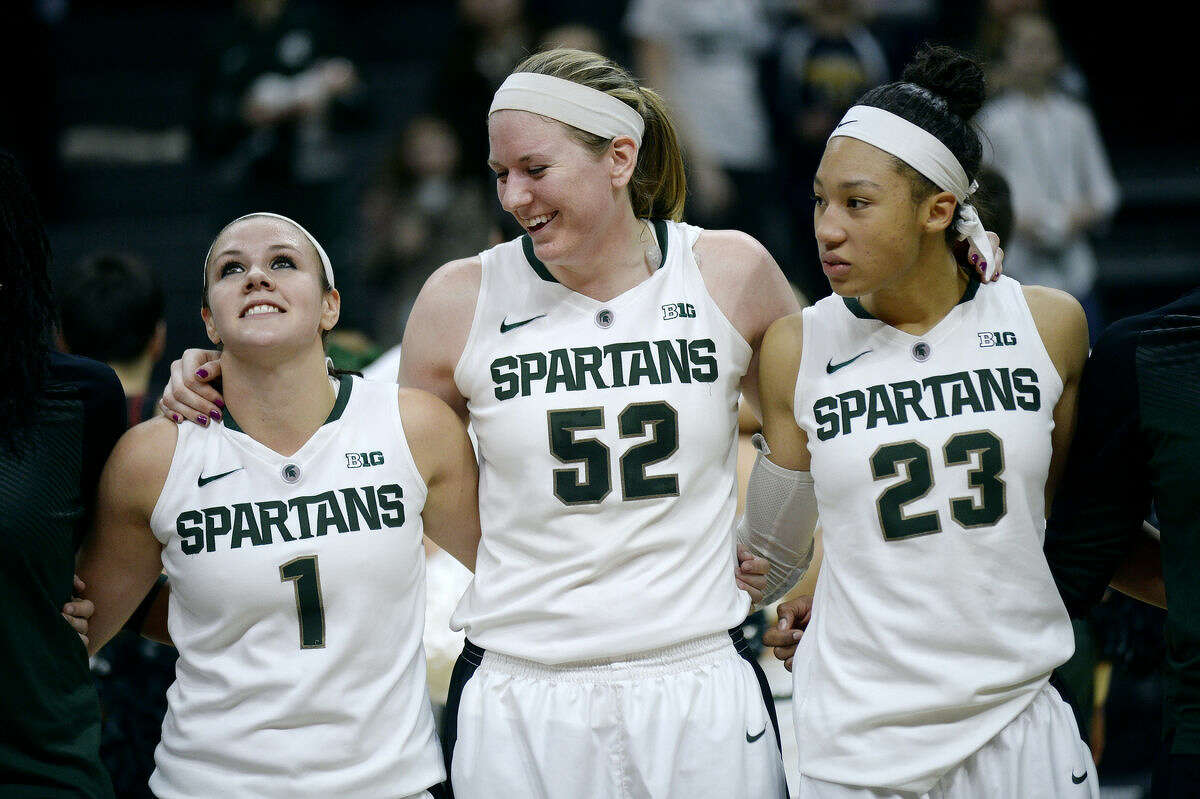 FILE — From left, Michigan State's Tori Jankoska, Becca Mills and Aerial Powers celebrate after the Spartans' victory over Indiana on Wednesday at the Breslin Center in East Lansing. Michigan State won 72-57.