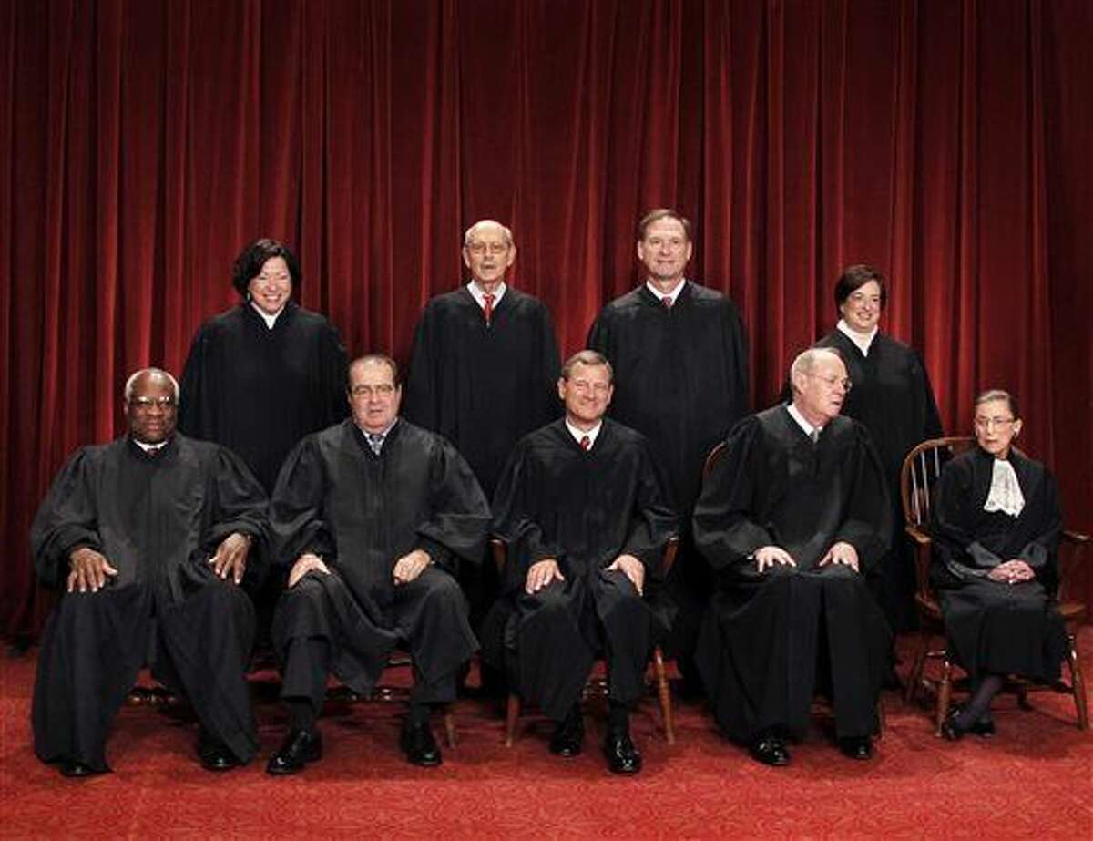 FILE - In this Oct. 8, 2010 file photo, the Supreme Court justices pose for a group photo at the Supreme Court in Washington. Seated, from left are, Justice Clarence Thomas, Antonin Scalia, Chief Justice John Roberts, Justice Anthony Kennedy, and Justice Ruth Bader Ginsburg. Standing, from left are, Justices Sonia Sotomayor, Stephen Breyer, Samuel Alito Jr., and Elena Kagan. On Saturday, Feb. 13, 2016, the U.S. Marshals Service confirmed that Scalia has died at the age of 79. (AP Photo/Pablo Martinez Monsivais, File)