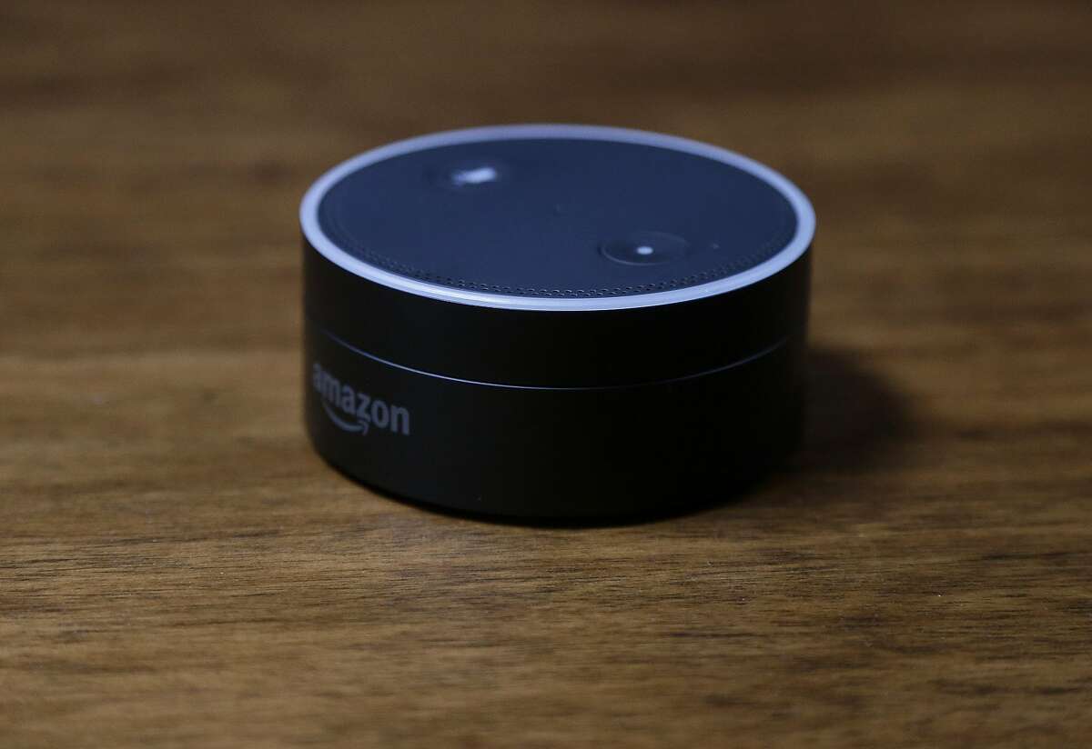 This March 2, 2016 photo shows an Echo Dot in San Francisco. Amazon.com introduced two devices, the Amazon Tap and Echo Dot, that are designed to amplify the role that its voice-controlled assistant Alexa plays in people's homes and lives.