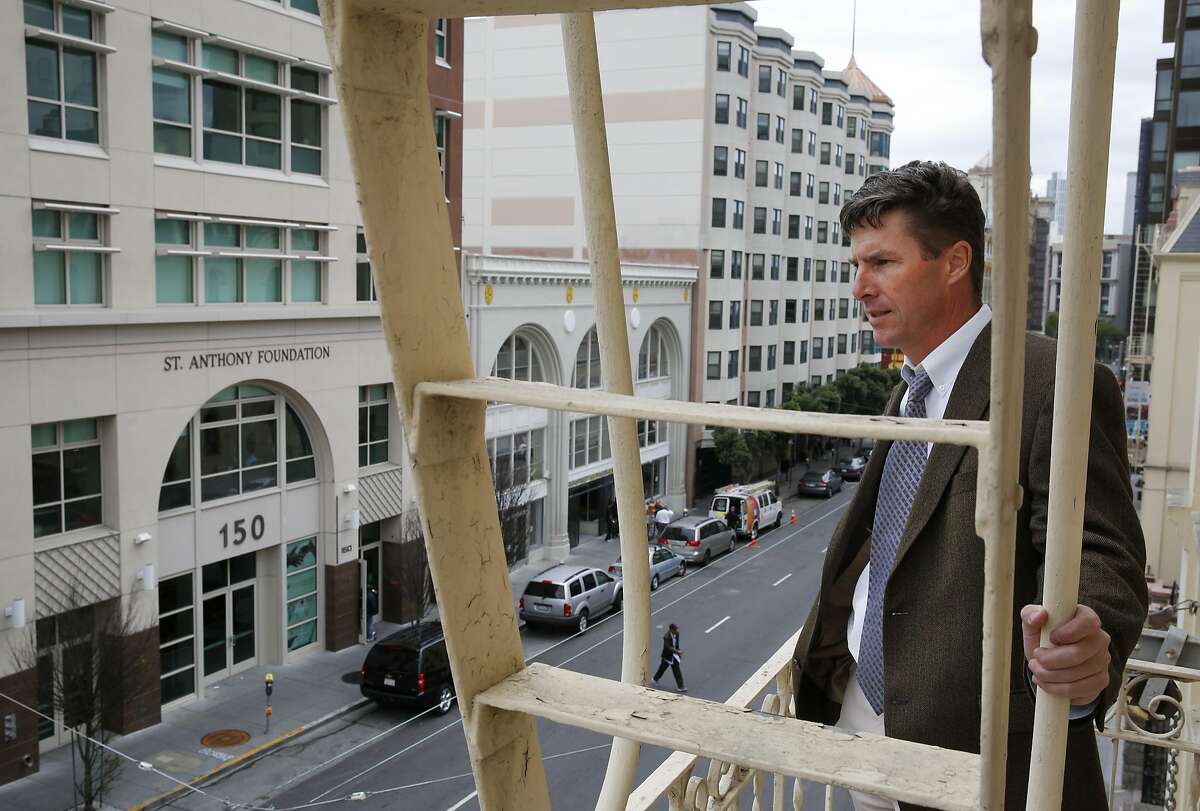 Mike Anderer, Vice President of Mission Advancement at De Marillac Academy poses for a portrait as he overlooks the corner of Golden Gate and Leavenworth from his school's fire escape May 7, 2015 across the street from the building 826 Valencia has signed a lease to take over in the Tenderloin in San Francisco, Calif. Among many other neighborhood duties, Anderer also facilitates the Golden Gate block safety group.
