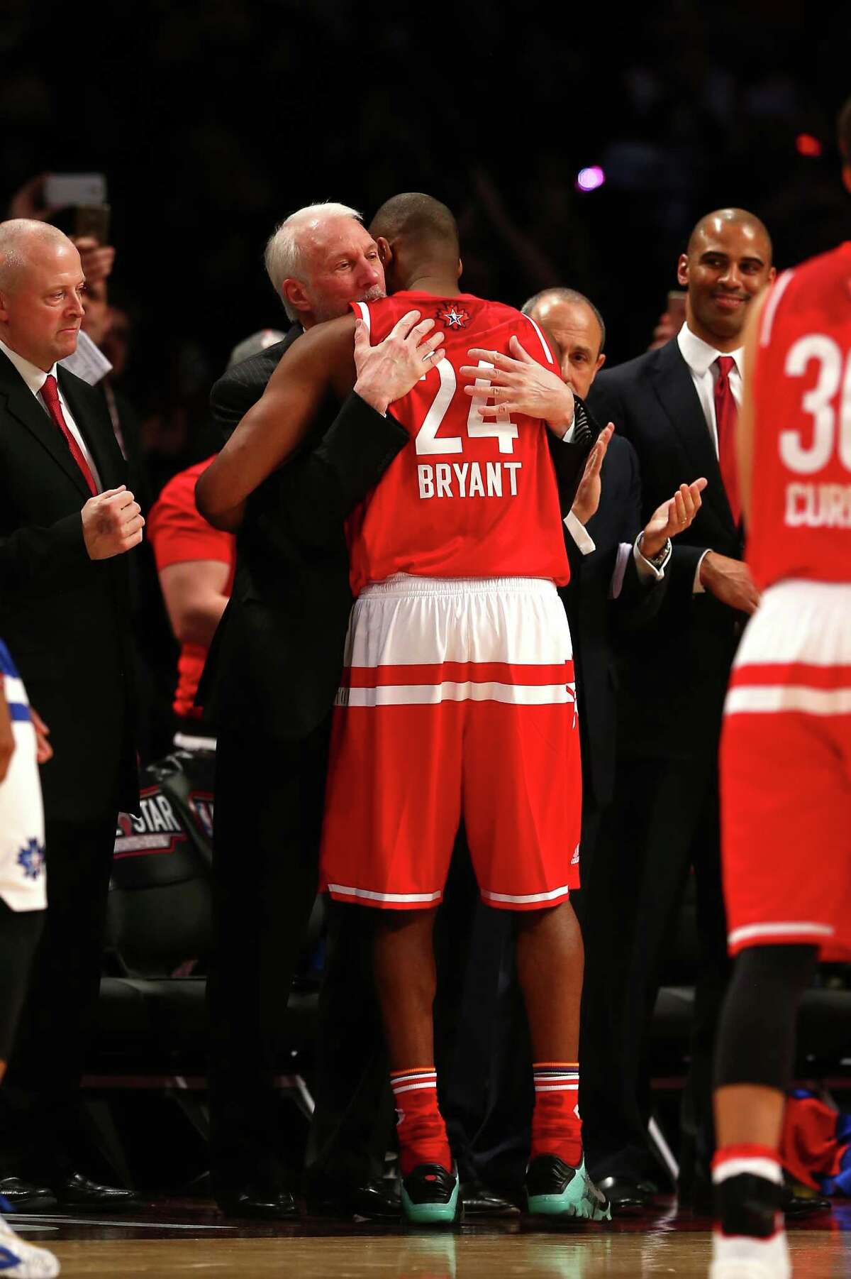 TORONTO, ON - FEBRUARY 14: Kobe Bryant #24 of the Los Angeles Lakers and the Western Conference hugs head coach Gregg Popovich as he walks to the bench in the fourth quarter against the Eastern Conference during the NBA All-Star Game 2016 at the Air Canada Centre on February 14, 2016 in Toronto, Ontario. NOTE TO USER: User expressly acknowledges and agrees that, by downloading and/or using this Photograph, user is consenting to the terms and conditions of the Getty Images License Agreement.