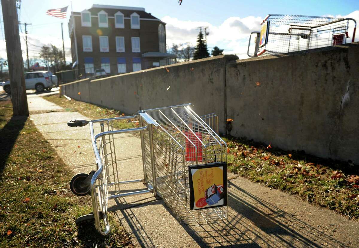 Shopping carts are blown from the parking lot outside Xpect Discounts at the intersection of High Street and the Post Road in Milford on Thursday, January 31, 2013.