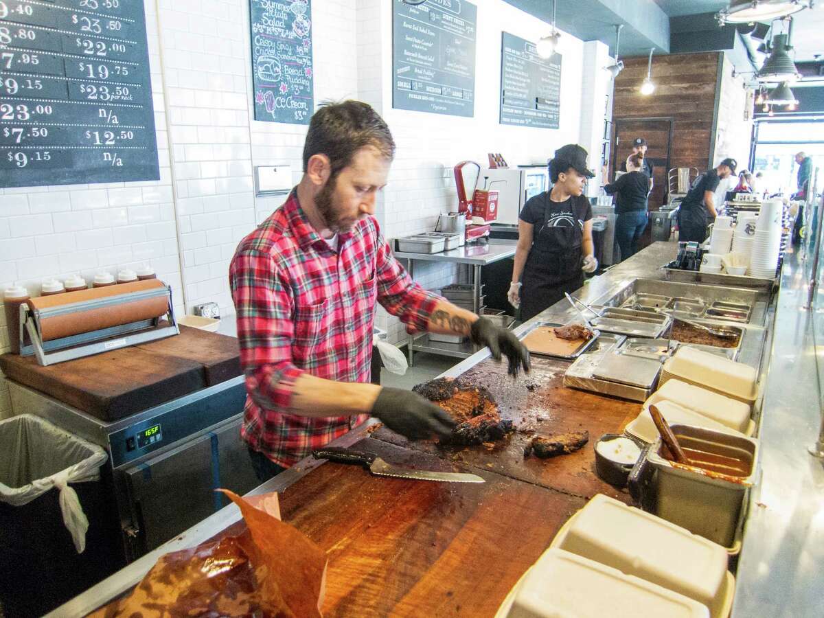 Hugh Mangum works at the chopping block at Mighty Quinn's Barbeque in the East Village in New York City.