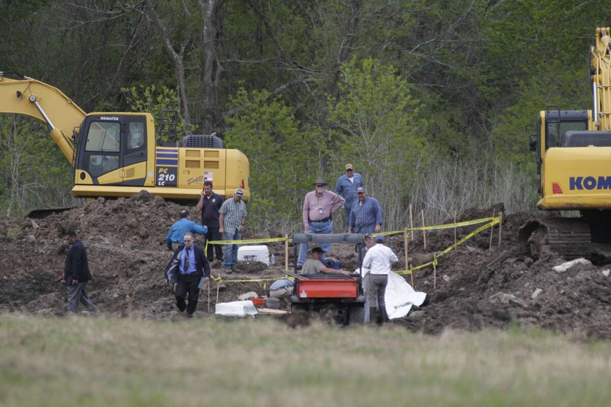 Searchers dig in a field for the remains of Jessica Cain, a teenager missing since 1997, in the 6100 block of E. Orem Dr., Friday, March 18, 2016, in Houston.