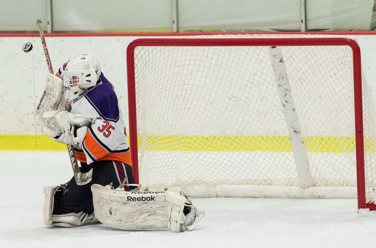 The Westhill-Stamford co-op team goalie Christian Compolattaro makes a save during a boys ice hockey game against Masuk High School played at Terry Connors Rink, Stamford, CT on Saturday, January 2, 2016.